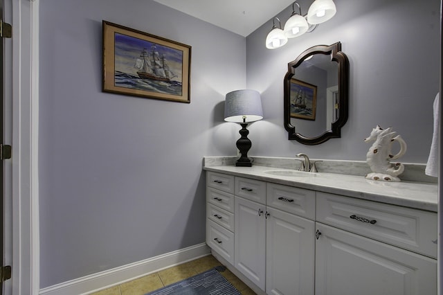 bathroom with vanity, baseboards, and tile patterned floors