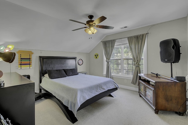 bedroom featuring light carpet, baseboards, visible vents, a ceiling fan, and vaulted ceiling