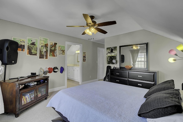 bedroom featuring lofted ceiling, a ceiling fan, light carpet, ensuite bath, and baseboards