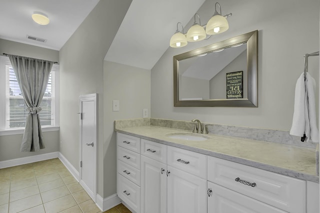 bathroom with baseboards, vanity, visible vents, and tile patterned floors