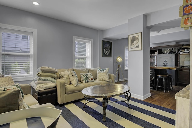 living room featuring recessed lighting, dark wood finished floors, and baseboards