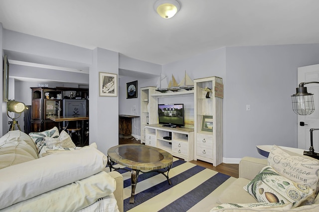 living area featuring dark wood finished floors and baseboards