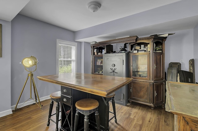 interior space featuring baseboards and wood finished floors