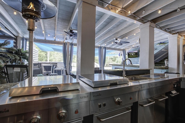 kitchen featuring plenty of natural light, ceiling fan, and a sink