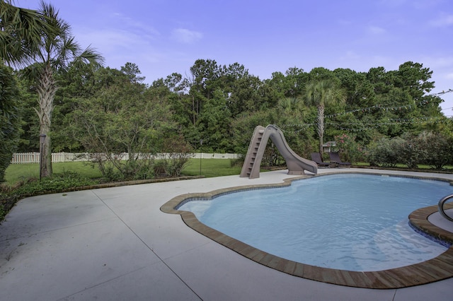 view of pool with a fenced in pool, a water slide, a patio area, and fence