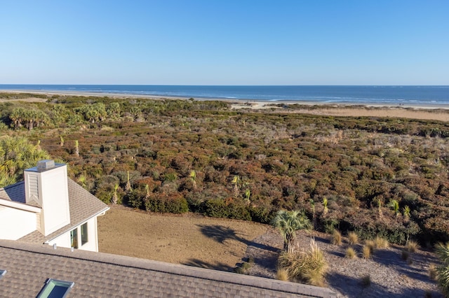 bird's eye view featuring a water view and a beach view