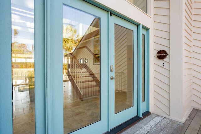 doorway to property featuring brick siding and french doors