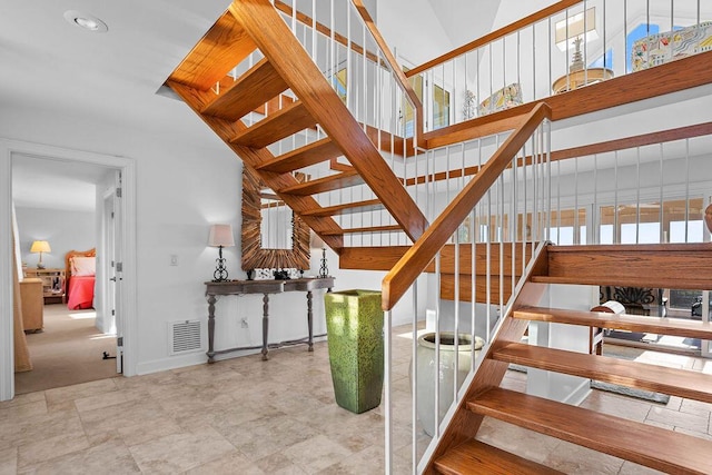 stairway with visible vents and baseboards