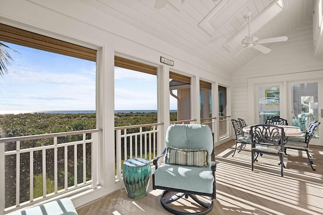 sunroom with lofted ceiling, wood ceiling, and a ceiling fan