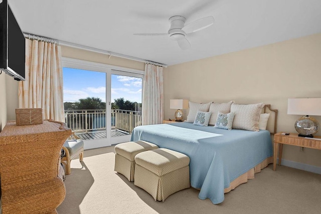 bedroom featuring access to exterior, carpet floors, baseboards, and a ceiling fan