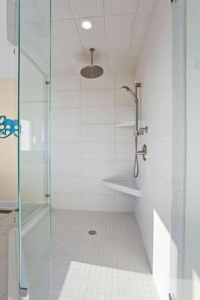 full bath featuring a sport court and a tile shower