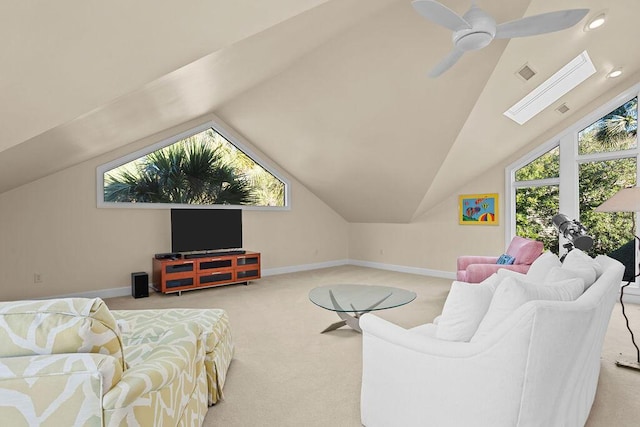 living room featuring lofted ceiling with skylight, carpet, visible vents, and baseboards