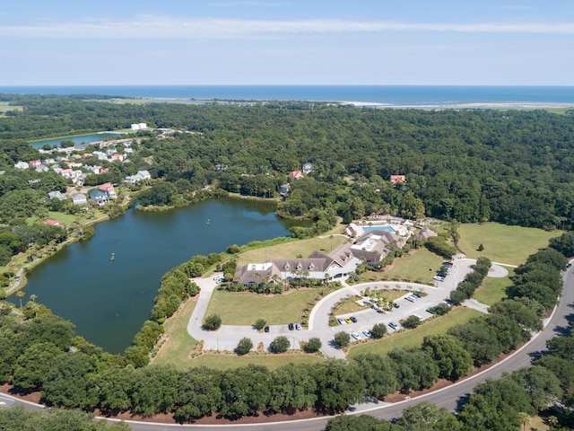 birds eye view of property featuring a water view and a view of trees