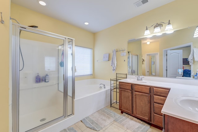 bathroom with plus walk in shower, tile patterned floors, and vanity