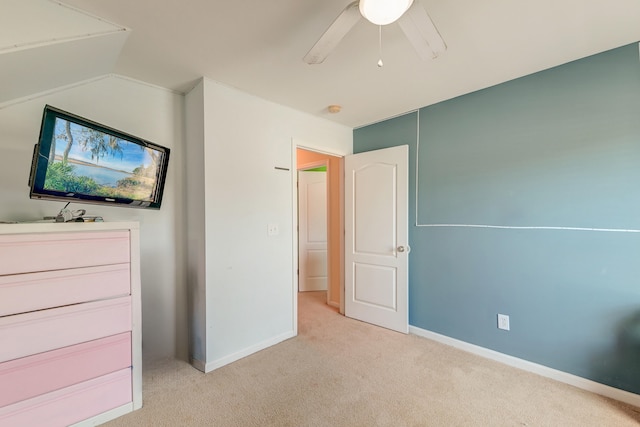 unfurnished bedroom with ceiling fan, light colored carpet, and lofted ceiling