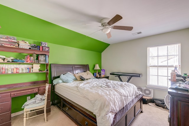 carpeted bedroom with ceiling fan and vaulted ceiling