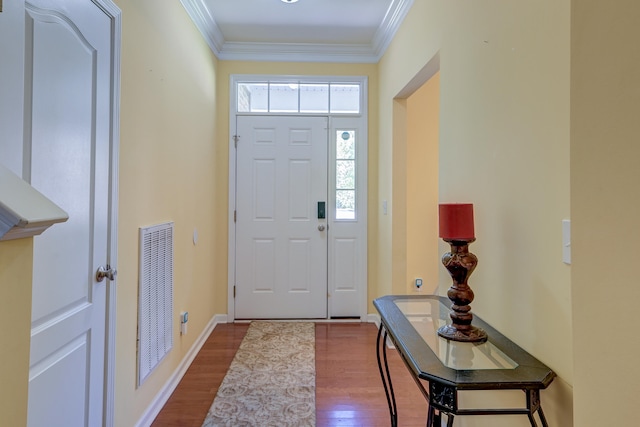 entrance foyer with wood-type flooring and ornamental molding