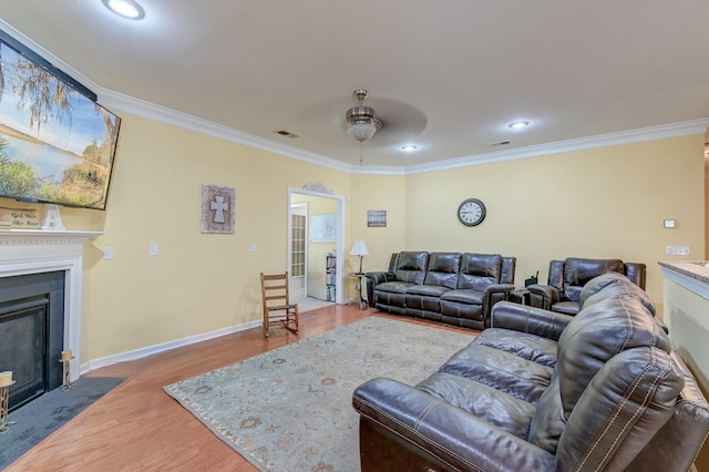 living room featuring ceiling fan, hardwood / wood-style flooring, and ornamental molding