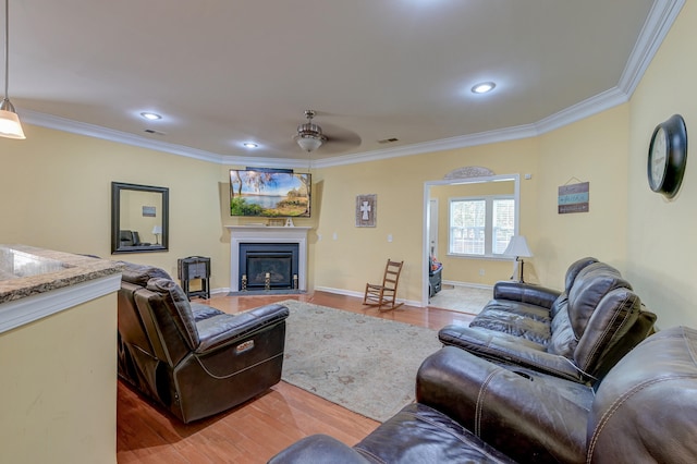 living room featuring ornamental molding, ceiling fan, and hardwood / wood-style flooring