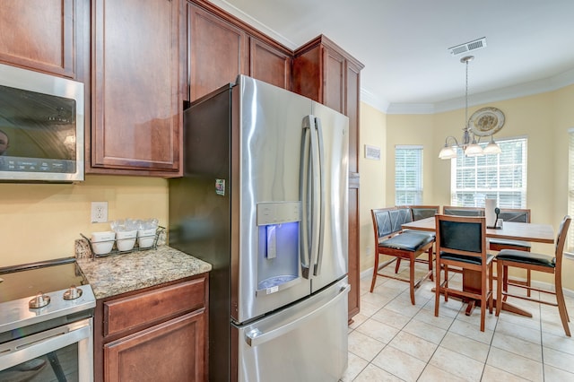 kitchen featuring a chandelier, hanging light fixtures, appliances with stainless steel finishes, light tile patterned floors, and crown molding