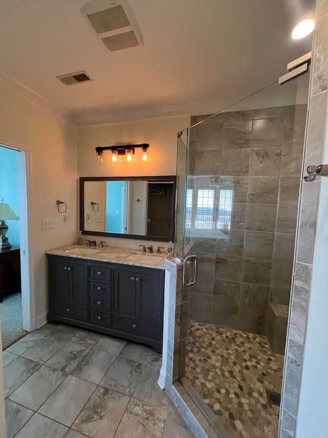 bathroom with vanity and a shower with door