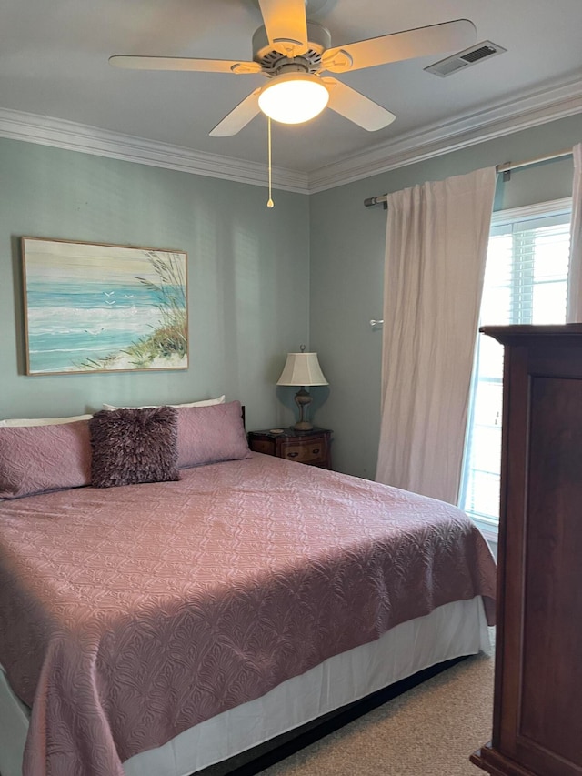 bedroom featuring ornamental molding, carpet, and ceiling fan