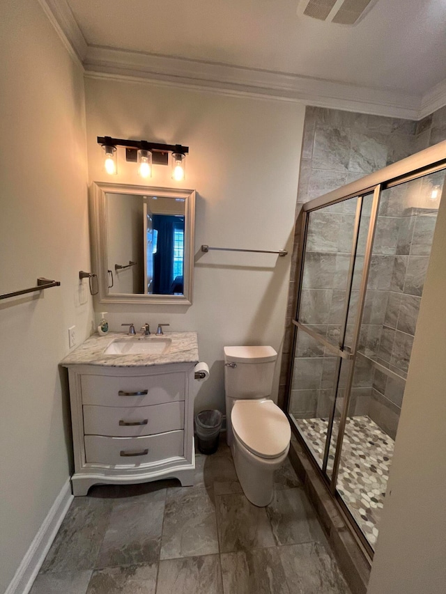 bathroom featuring vanity, crown molding, a shower with shower door, and toilet