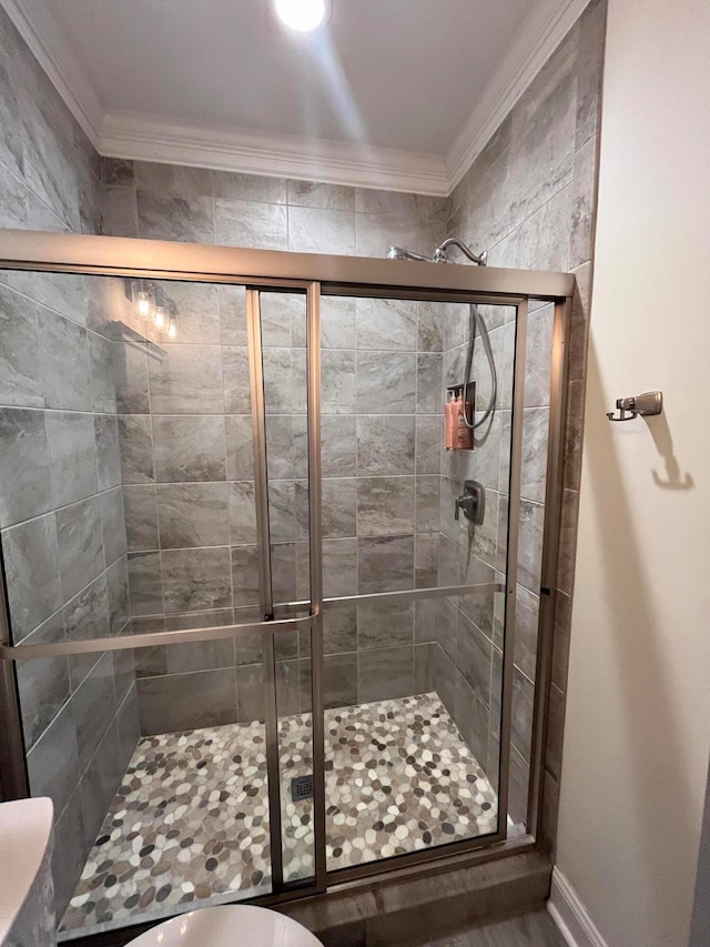 bathroom featuring crown molding and walk in shower