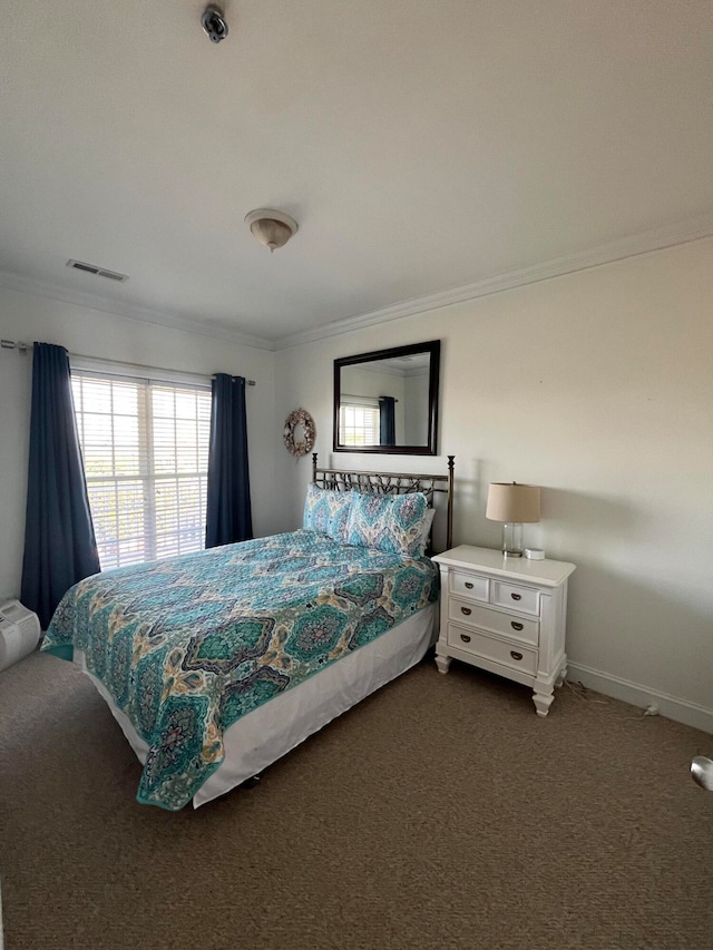 bedroom featuring crown molding and dark colored carpet