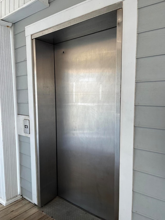 room details with wooden walls and elevator