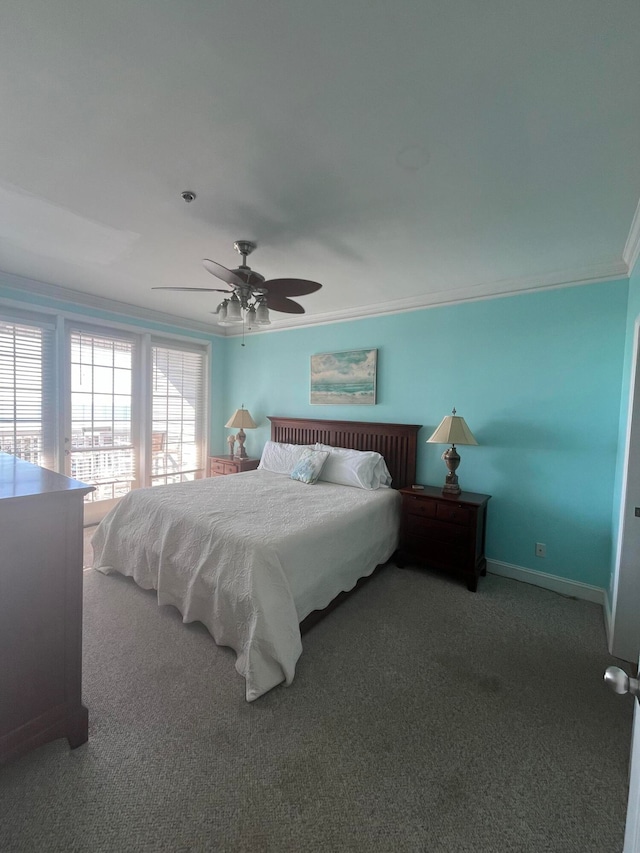 carpeted bedroom featuring ceiling fan and crown molding