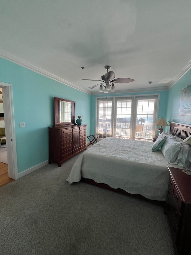 carpeted bedroom featuring ornamental molding and ceiling fan