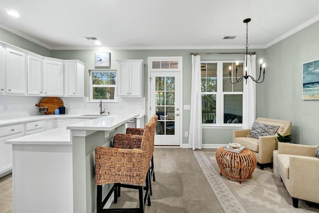 kitchen featuring a kitchen bar, tasteful backsplash, white cabinetry, and sink