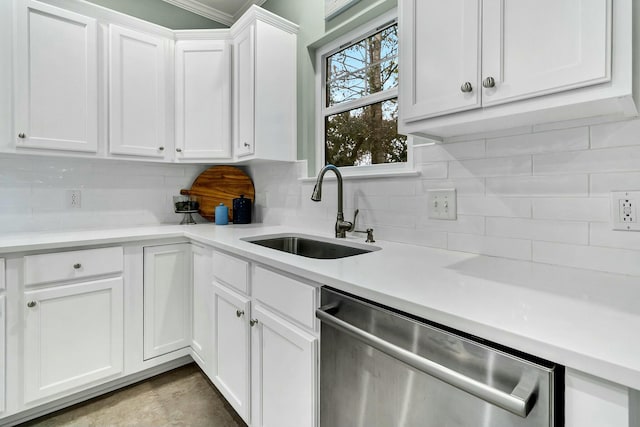 kitchen with tasteful backsplash, stainless steel dishwasher, crown molding, sink, and white cabinets