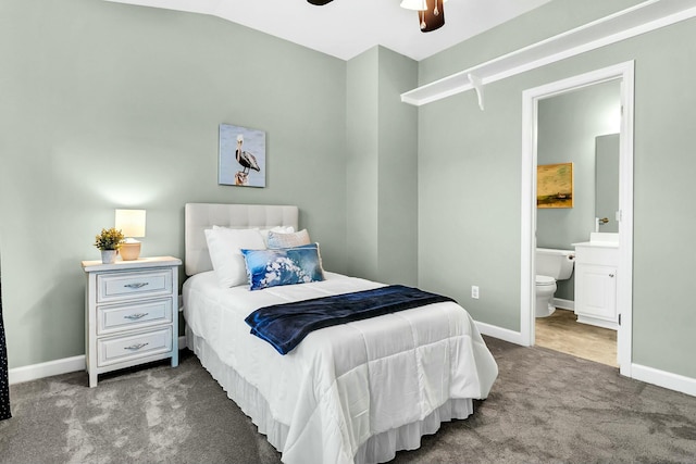 carpeted bedroom featuring connected bathroom, vaulted ceiling, and ceiling fan