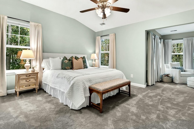 carpeted bedroom featuring multiple windows, ceiling fan, and lofted ceiling