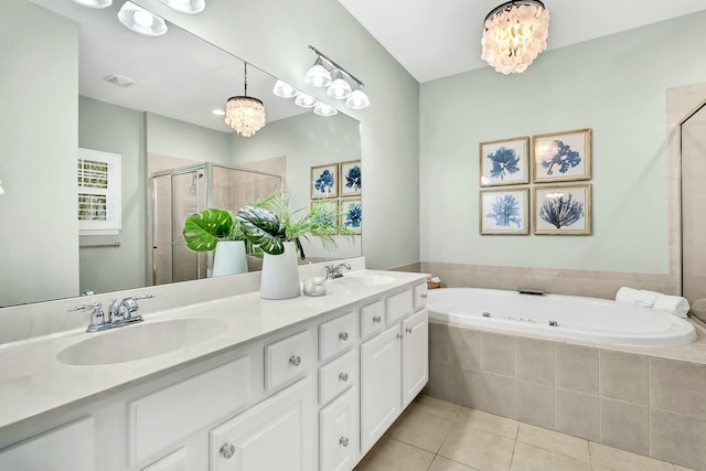 bathroom featuring tile patterned flooring, vanity, shower with separate bathtub, and a chandelier