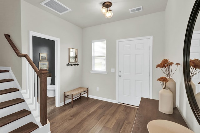 entryway featuring wood finished floors, stairway, and baseboards
