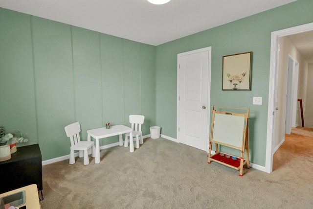 recreation room with carpet floors and baseboards