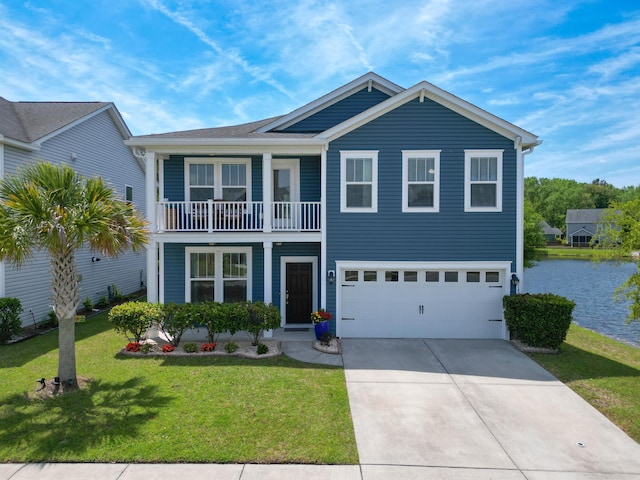 traditional-style house featuring a water view, a front lawn, a balcony, an attached garage, and driveway