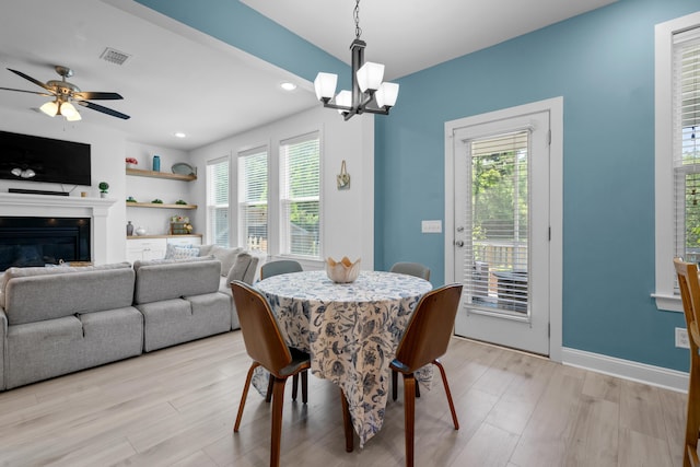 dining space featuring visible vents, light wood finished floors, recessed lighting, and ceiling fan with notable chandelier