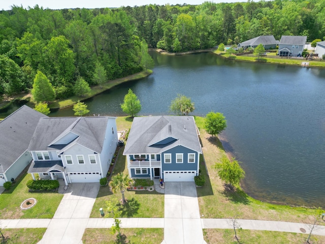 birds eye view of property with a water view and a view of trees