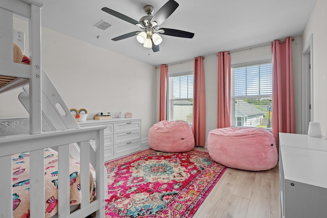 bedroom with visible vents, light wood-type flooring, and ceiling fan