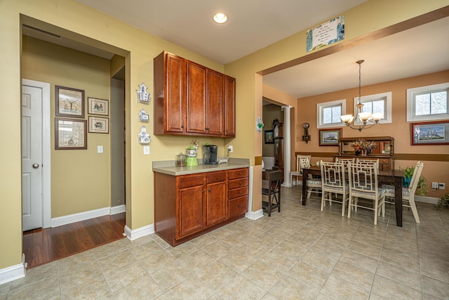 kitchen featuring light tile patterned flooring, hanging light fixtures, and an inviting chandelier