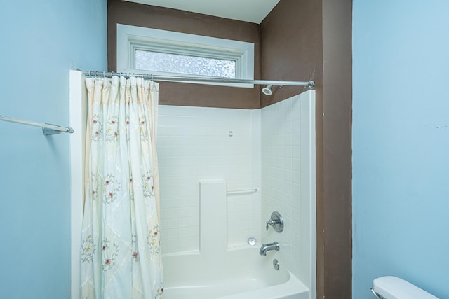 bathroom with shower / tub combo and toilet