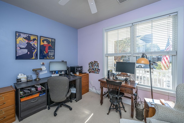 carpeted office space featuring plenty of natural light and ceiling fan