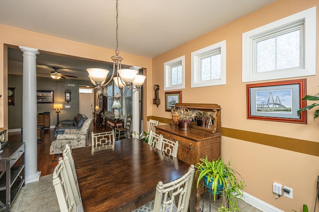 tiled dining space with ornate columns and ceiling fan with notable chandelier