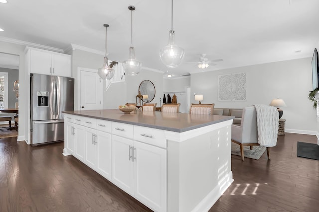 kitchen featuring stainless steel fridge, a center island, white cabinets, and dark wood-type flooring