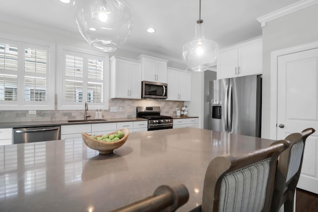 kitchen with white cabinetry, sink, appliances with stainless steel finishes, and tasteful backsplash