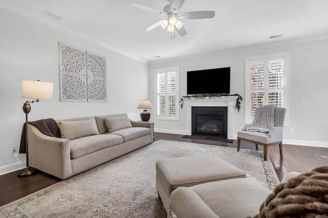 living room with wood-type flooring, ceiling fan, and ornamental molding